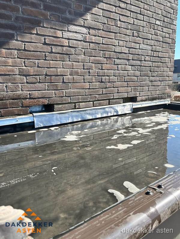 Stilstaand water op plat dak door slechte afwatering in Asten Stilstaand water op plat dak door slechte afwatering in Asten
